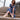 Elkie wide fit gold leather platform sandals worn on model in blue dress, seated on steps