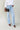 Tall woman wearing MODACCIO Livia Jean in light wash denim with white button-down shirt