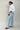 Profile view of tall model wearing MODACCIO Livia Jean in light wash denim