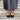 Lorna wide fit black leather T-bar heels worn on model, front view