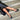 Lorna wide fit black leather T-bar heels worn on model, second angle