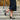 Lorna wide fit black leather T-bar heels worn on model, side profile
