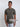 An upper body shot of a tall slim guy wearing a dark grey medium tall t-shirt.