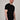 A tall and slim man in the studio standing in front of a light background. The smiling model is wearing an extra long slim black t-shirt in a size XL. The tall black t-shirt features a 3" longer body, 100% organic cotton, and is soft & preshrunk. The black t-shirt is ideal for tall slim men 6'2"+.