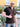 A tall slim guy wearing a black XL tal zip polo , thumbs up and smiling.