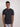 A tall and slim man in the studio standing in front of a light background. The smiling model is wearing an extra long slim charcoal t-shirt in a size medium. The tall charcoal  t-shirt features a 3" longer body, 100% organic cotton, and is soft & preshrunk. The charcoal t-shirt is ideal for tall slim men 6'2"+.