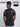 A shot from behind of a tall and slim guy in a studio and wearing a charcoal medium tall slim t-shirt.