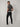 A shot from behind of a tall skinny guy wearing a tall grey pique polo shirt.