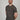 A tall and slim man in the studio standing in front of a light background with hands behind back. The smiling model is wearing an extra long slim dark grey v-neck t-shirt in a size XL. The tall dark grey v-neck t-shirt features a 3" longer body, 100% organic cotton, and is soft & preshrunk. The dark grey v-neck t-shirt is ideal for tall slim men 6'2"+.