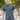 A tall and athletic man in a park standing on a path between trees. The smiling model is wearing an extra long slim dark slate polo shirt in a size XL. The tall dark slate polo shirt features a 3" longer body, 100% organic cotton, and is soft & preshrunk. The dark slate polo shirt is ideal for tall slim men 6'2"+. Buy 2 Save 10%, Buy 4 Save 15%, Buy 6 Save 20%.
