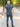 A shot from behind of a tall athletic guy in a park and wearing a dark slate XL tall polo shirt.