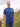 A tall and slim man standing by the sea. The smiling model is wearing a navy blue extra long graphic t-shirt with a minimal lake design. It features a 3" longer body, 100% organic cotton, and is soft & preshrunk. This extra long tall graphic tee is ideal for tall slim men 6'2"+