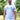 An upper body shot of a tall slim guy in a park wearing an XL tall and slim fitting graphic t-shirt in white.