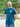 An upper body shot of a tall slim guy in a park wearing an XL tall and slim fitting graphic t-shirt in dark teal.