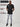 A head to toe shot of a tall slim guy wearing a large tall heavyweight black t-shirt.