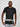A tall slim guy wearing a large tall black heavyweight t-shirt, pulling gently down on the bottom seam to show the extra length.
