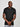 An upper body shot of a tall slim guy wearing a large tall heavyweight black t-shirt, looking down and smiling.