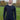 A tall and slim man standing in a park. The smiling model is wearing a black long-sleeve tall t-shirt. The tall black long-sleeve t-shirt features a 2.5" longer sleeves, 100% organic cotton, and is soft & preshrunk. The black long-sleeve t-shirt is ideal for tall slim men 6'2"+.