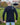 A shot from behind of a tall slim guy in a park wearing an extra long sleeve long sleeve tall t-shirt in black.