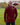 A shot from behind of a tall athletic guy wearing an XL tall maroon long sleeve t-shirt, standing in a park.