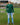 A head to toe shot of a tall athletic guy in a park wearing a dark green long sleeve tall t-shirt.