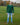 A head to toe shot of a tall athletic guy in a park, looking up at the sky and wearing a dark green long sleeve tall t-shirt.