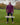 An upper body shot of a tall athletic guy standing in a park wearing a dark purple extra long tall long sleeve t-shirt and showing  the Just Tall minimalist monogram logo.