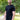 An upper body shot of a tall slim guy in a park wearing an XL tall and slim fitting mercerised t-shirt in black.