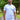 An upper body shot of a tall slim guy in a park wearing an XL tall and slim fitting mercerised t-shirt in white.
