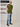A head to toe shot of a tall muscular guy  in a studio and wearing an olive XL tall t-shirt.