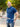 An upper body shot of a tall athletic guy in a park and wearing an XL tall slim navy polo shirt and showing the minimal Just Tall flag logo near the bottom of the side seam.