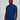 A tall and slim man in the studio standing in front of a light background. The smiling model is wearing an extra long slim navy t-shirt in a size large. The tall navy t-shirt features a 3" longer body, 100% organic cotton, and is soft & preshrunk. The navy t-shirt is ideal for tall slim men 6'2"+.