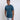 A tall and slim man in the studio standing in front of a light background. The smiling model is wearing an extra long slim petrol t-shirt in a size medium. The tall medium t-shirt features a 3" longer body, 100% organic cotton, and is soft & preshrunk. The medium t-shirt is ideal for tall slim men 6'2"+.