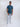 A head to toe shot of a tall slim guy  in a studio and wearing a petrol medium tall slim t-shirt.