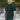 A tall and athletic man in a park standing on a path between trees. The smiling model is wearing an extra long slim dark pine polo shirt in a size XL. The tall dark pine polo shirt features a 3" longer body, 100% organic cotton, and is soft & preshrunk. The dark pine polo shirt is ideal for tall slim men 6'2"+. Buy 2 Save 10%, Buy 4 Save 15%, Buy 6 Save 20%.