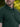 A close-up of the stay-flat collar of a tall dark pine polo shirt.