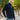 A tall and slim man standing on a path in  a park. The smiling model is wearing a black quarter zip sweatshirt. The tall black quarter zip sweatshirt features 2.5" longer sleeves, 100% organic french terry cotton, and is soft & comfy. It's  ideal for tall slim men 6'2"+.