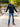 A head to toe shot of a tall athletic guy in a park wearing an XL tall extra long black quarter zip sweatshirt.
