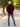 A shot from behind of a tall slim guy in a park wearing an XL tall extra long maroon quarter zip sweatshirt.
