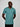 A tall and slim man in the studio standing in front of a light background with hands behind back. The smiling model is wearing an extra long slim teal v-neck t-shirt in a size large. The tall teal v-neck t-shirt features a 3" longer body, 100% organic cotton, and is soft & preshrunk. The teal v-neck t-shirt is ideal for tall slim men 6'2"+.