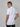 A shot from behind of a tall slim guy in a studio and wearing a white M tall polo shirt.