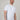 A tall and slim man in the studio standing in front of a light background. The smiling model is wearing an extra long slim white t-shirt in a size XL. The tall white t-shirt features a 3" longer body, 100% organic cotton, and is soft & preshrunk. The white t-shirt is ideal for tall slim men 6'2"+.