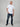 A head to toe shot of a tall and slim guy in the studio wearing a white XL tall slim t-shirt.
