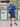 A head to toe shot of a tall and broad guy standing in a tennis court and wearing a 2XL Tall dark navy zip-up hoodie.