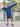 A tall and muscular guy standing in a tennis court and wearing an XL tall dark navy hoodie.
