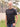 A tall skinny guy wearing a tall black henley shirt and smiling.