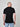 A shot from behind of a tall and slim guy in the studio and wearing a black XL tall slim v-neck t-shirt.