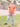 A tall skinny guy wearing a tall brown henley shirt and smiling.
