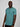 A tall and slim guy smiling in the studio and wearing a teal L tall slim v-neck t-shirt.